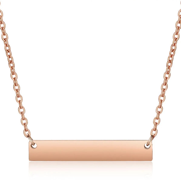A gold-colored horizontal bar necklace made of stainless steel, displayed on a white background.